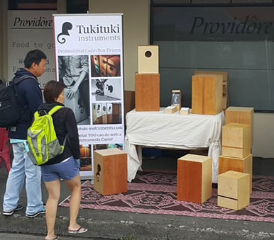 Tukituki Instruments display with cajons for sale at a local market in New Zealand